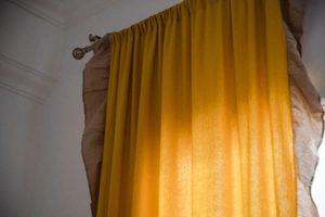 Vista dettagliata della tenda da cucina patchwork gialla e beige con balze a pieghe