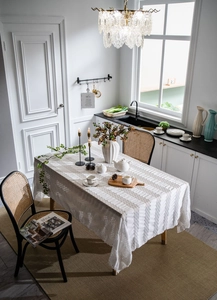 Detail of French vintage off-white tablecloth featuring pleated texture and ruffled edges