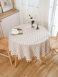 Detailed view of blue floral cotton linen tablecloth with delicate white fringe edge