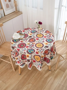 Detail of bohemian mandala print round tablecloth with delicate white lace border edge
