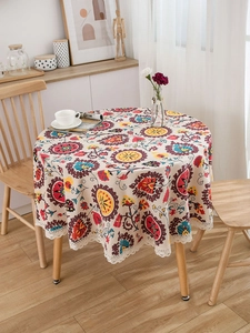 Close-up of bohemian round tablecloth with mandala patterns and white lace edges