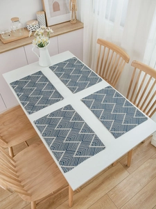 Detailed macro view of navy blue woven placemat showing intricate geometric jacquard pattern