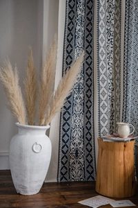 Detail of blue geometric floral print on thick cotton linen bohemian curtain fabric