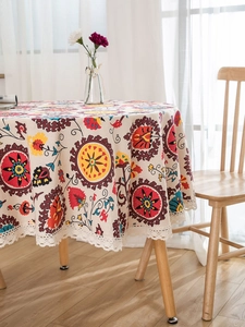 Close-up of bohemian round tablecloth with mandala patterns and white lace edges