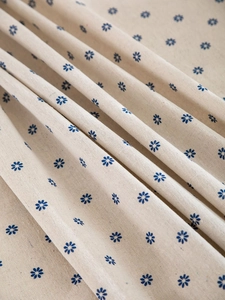 Macro view of blue floral pattern on cotton linen fabric with high-quality weave texture