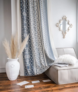 Detail of blue and white floral cotton linen curtains in a Mediterranean style setting