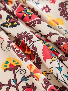 Close-up of Bohemian printed tablecloth with vibrant floral patterns and cotton linen texture