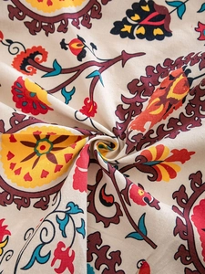 Macro detail of Bohemian round tablecloth fabric with ethnic floral patterns and soft texture