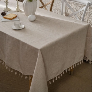 Solid beige linen blend tablecloth with elegant white fringe tassels for dining tables