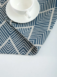 Detailed view of the navy blue wave pattern placemat with high-quality woven textures