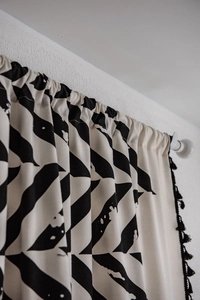Detail of minimalist cotton linen curtain with black geometric abstract leaf patterns