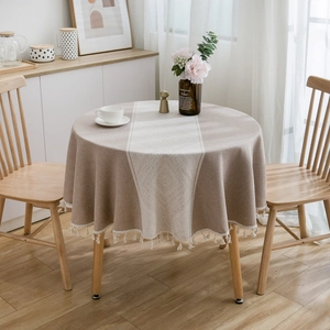 Bohemian round tablecloth with geometric patterns and elegant tassels on a wooden table