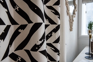 Close-up of black and white geometric leaf print curtain with thick fabric texture