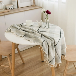 Linen-textured plaid round tablecloth with tassel fringe for cozy home dining decor