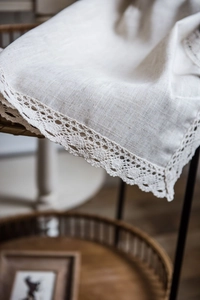 Detail of natural beige linen curtain fabric with exquisite crochet lace border