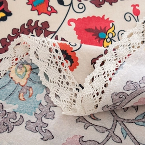 Ethnic bohemian round tablecloth with vibrant floral prints and white lace edges