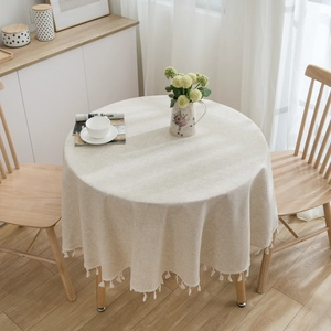 Minimalist beige linen round tablecloth with decorative white tassels for home dining