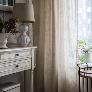 Minimalist beige linen texture curtain with elegant lace trim in a cozy home setting