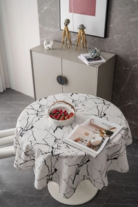 Detail of round marble print tablecloth with a focus on drape and thick fabric texture