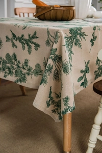 Detailed close-up of pine needle and bird print on linen cotton tablecloth fabric texture