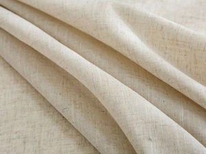 Detail shot of natural linen texture with soft folds and elegant woven pattern
