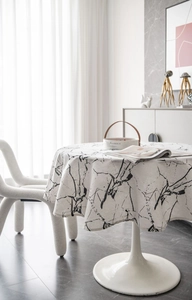 Detailed view of modern marble pattern round tablecloth in beige with ink textures