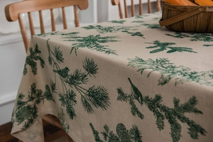 Detailed view of linen texture tablecloth featuring vintage pine needles and bird prints