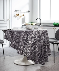 Detail of round cotton linen tablecloth with black and white Aztec geometric patterns