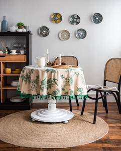 Close-up of green pine needle print cotton linen tablecloth with tassels and fringe detail