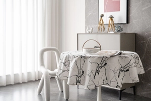 Close-up of marble texture on a modern round tablecloth with elegant beige fabric draping