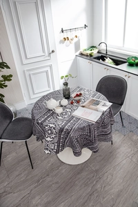 Top view of a bohemian round tablecloth with geometric patterns on a dining table