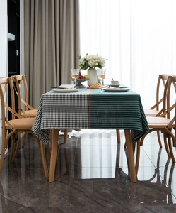 Detail view of thickened dark green houndstooth jacquard tablecloth on a dining table