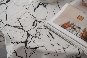 Detail of marble pattern on minimalist round tablecloth with cotton linen texture