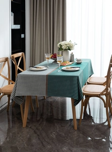 Detail of green and houndstooth patchwork tablecloth with elegant orange stripe accents