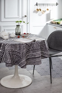 Detailed texture of grey and white bohemian geometric pattern on round tablecloth