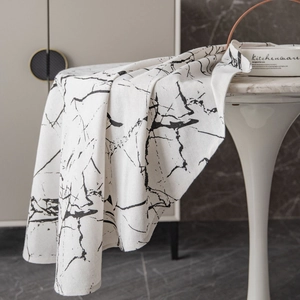 Modern marble print round tablecloth in white and black with natural drape fabric