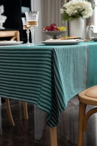 Macro detail of dark green houndstooth jacquard tablecloth with premium fabric texture