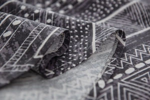 Macro detail of bohemian geometric print fabric with high-quality overlock stitching