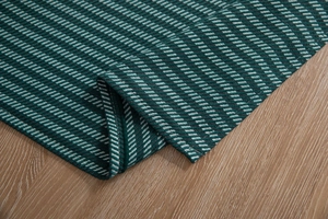 Detail shot of heavy green jacquard tablecloth texture and premium woven houndstooth pattern