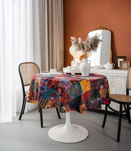 Detail of round bohemian tablecloth featuring multi-colored mandala and ethnic prints