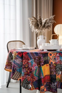 Detail of bohemian multicolored paisley printed round tablecloth with elegant drape