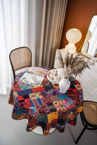 Close-up of bohemian round tablecloth with colorful mandala patterns and cotton linen texture