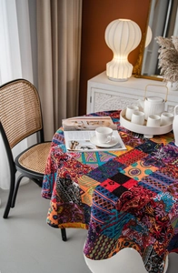 Detail of bohemian round tablecloth featuring vibrant paisley prints and cotton linen texture