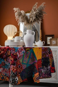 Detailed Bohemian patchwork tablecloth with vibrant floral patterns and exotic textures