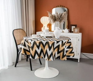 Detailed view of bohemian geometric wave pattern on a round cotton linen tablecloth