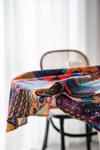 Detail of colorful Bohemian table cloth with ethnic floral patterns and fabric texture