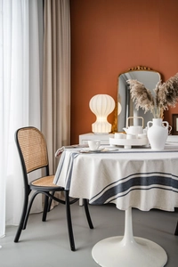 Close-up of navy blue striped cotton linen tablecloth on a round white tulip table