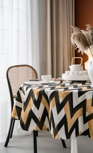 Detailed close-up of modern geometric chevron pattern tablecloth with mustard yellow and black