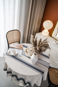 Close-up of navy blue striped round cotton linen tablecloth with natural texture