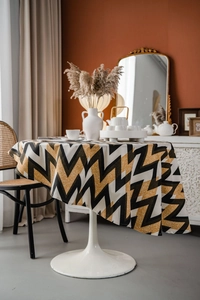 Detail of bohemian round tablecloth with yellow and black zigzag geometric patterns